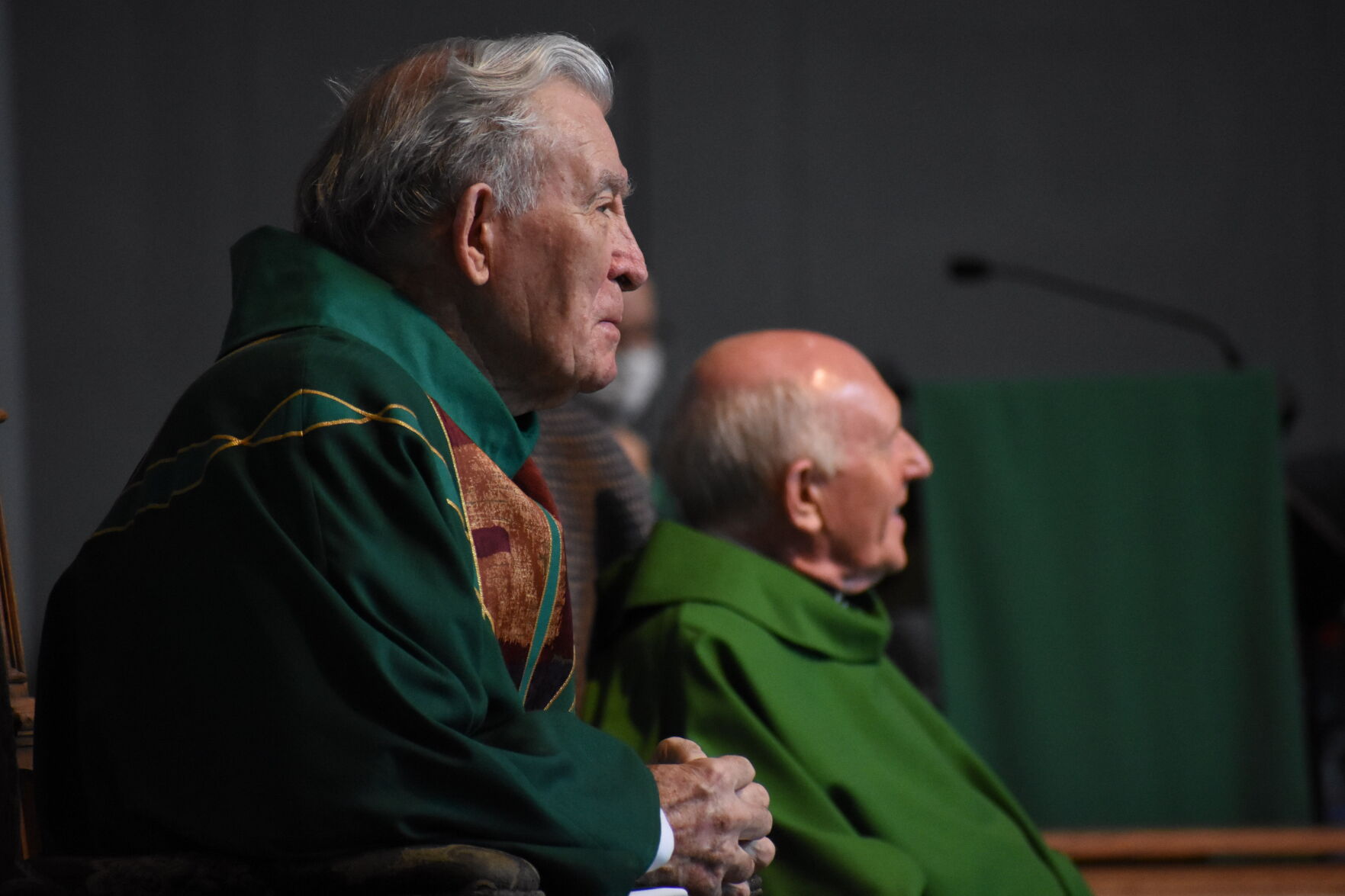 Monsignor John Bluett (left) and Blessed Sacrament Father George Dunne listen to Bishop John Noonan as he speaks on the day of the two priests’ retirement, June 13 at St. Stephen Parish, Winter Springs.